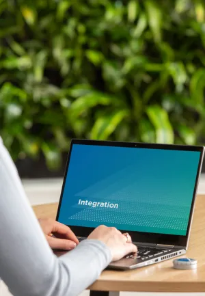 HumanTech person using laptop wearing headphones